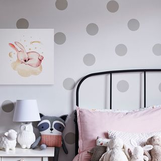 A canvas print above a nightstand beside a child's bed.
