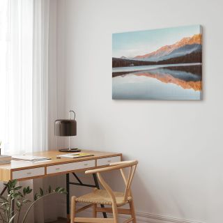 A canvas print hung beside a home work desk.