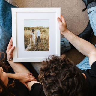 Top view of a couple looking down at a custom framed print