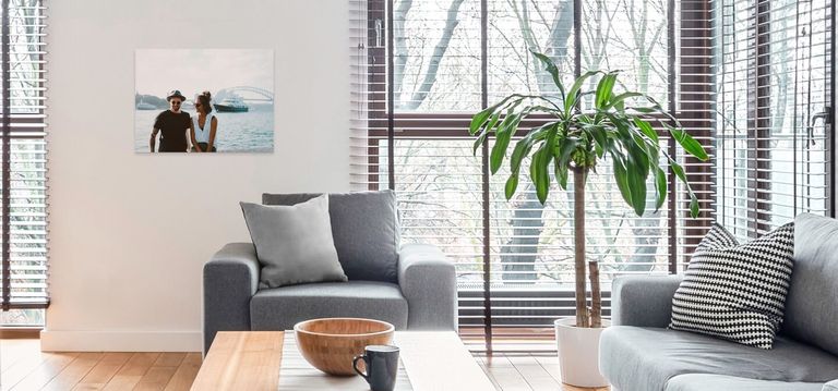 A canvas print hanging above a chair in a living room.