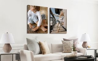 Two canvas print hanging over a couch. One of young child playing on the floor, the other of an older child leaning away from a dock railing