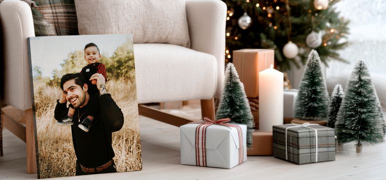 Canvas print in living room with Christmas decorations of father and son. 