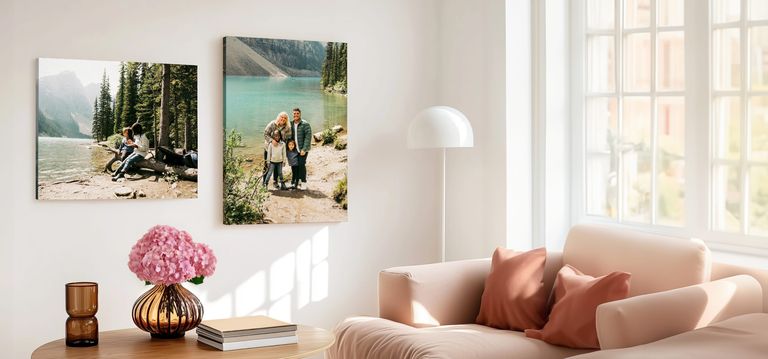 Two canvas print hanging in living room. One of young children playing near the lake, the other of a family portrait at the lake.