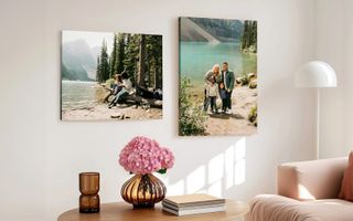 Two canvas print hanging in living room. One of young children playing near the lake, the other of a family portrait at the lake.