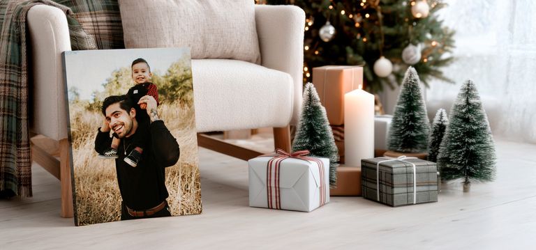 Canvas print in living room with Christmas decorations of father and son. 