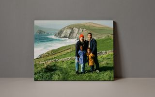 Canvas print of people in front of the mountains on a black background.
