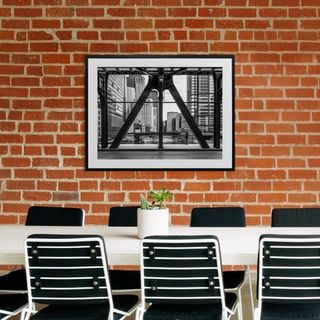 A canvas print positioned above a meeting room table
