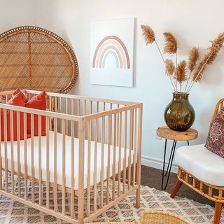 A canvas print above a baby's crib.