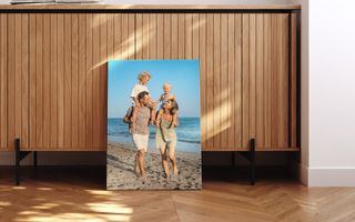 Couple walking on a beach with their kids
