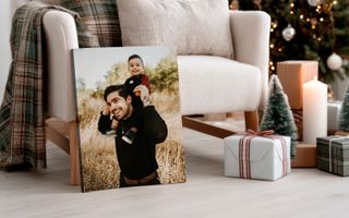 Canvas print in living room with Christmas decorations of father and son. 