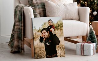 Canvas print in living room with Christmas decorations of father and son. 