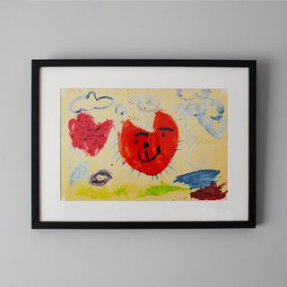 A framed print displaying a child's drawing.