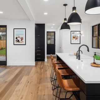 A framed print hung next to a kitchen island.