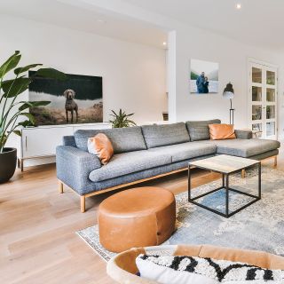A canvas print hung behind in a foyer, behind a couch.